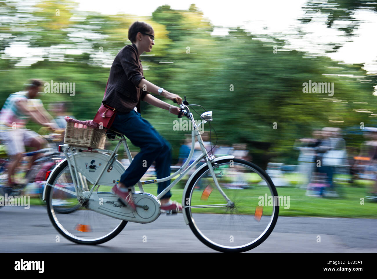 Woman riding white classic city bike Stock Photo