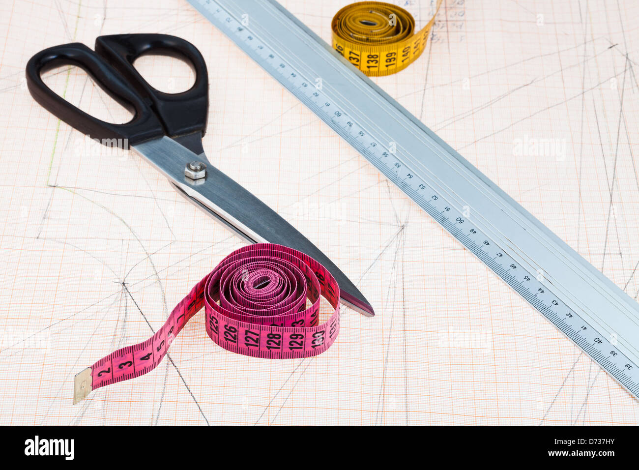 dress pattern at graph paper and tailors shears, ruler, measure tapes Stock Photo