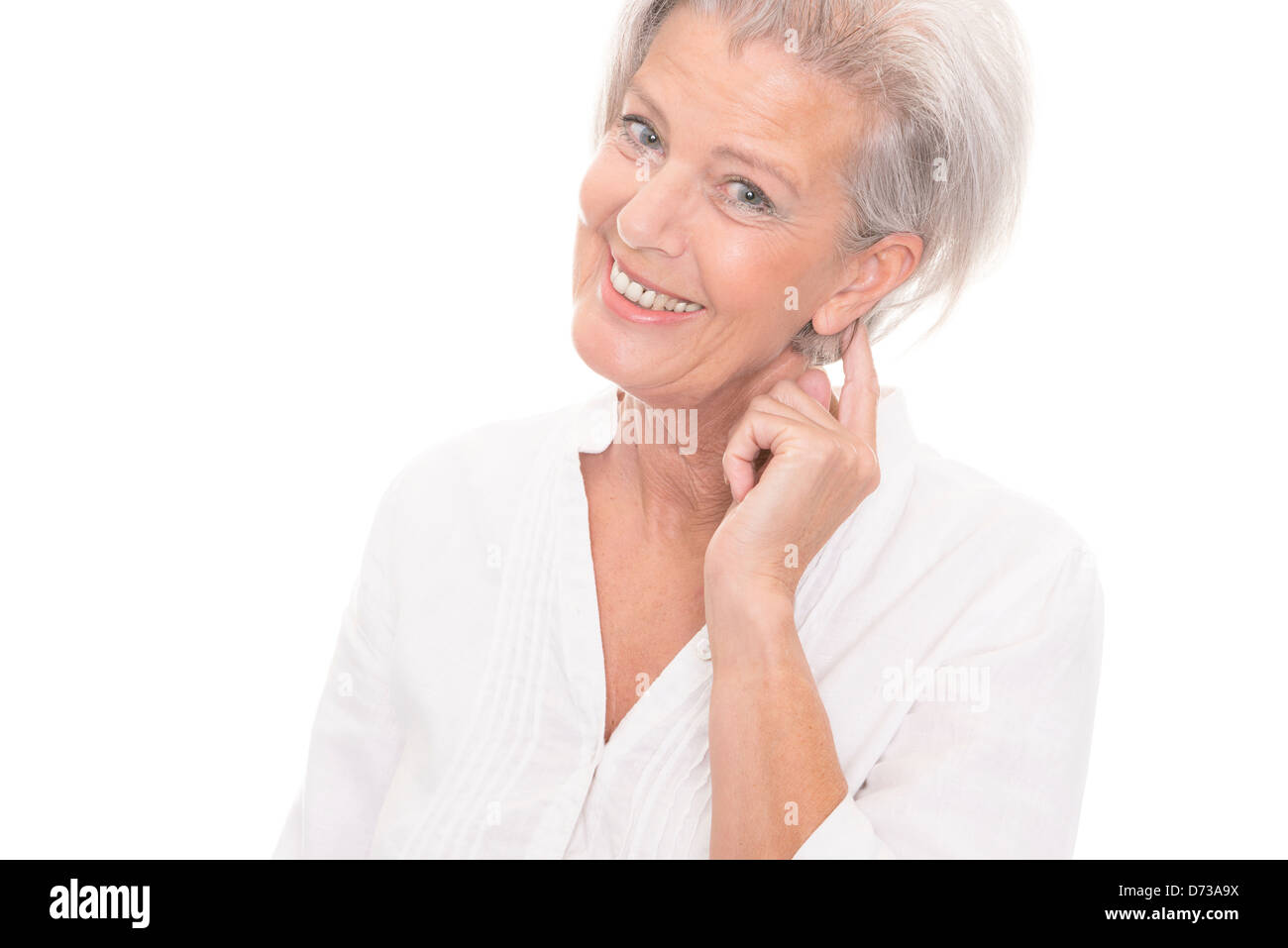 Smiling senior woman in front of white background Stock Photo - Alamy