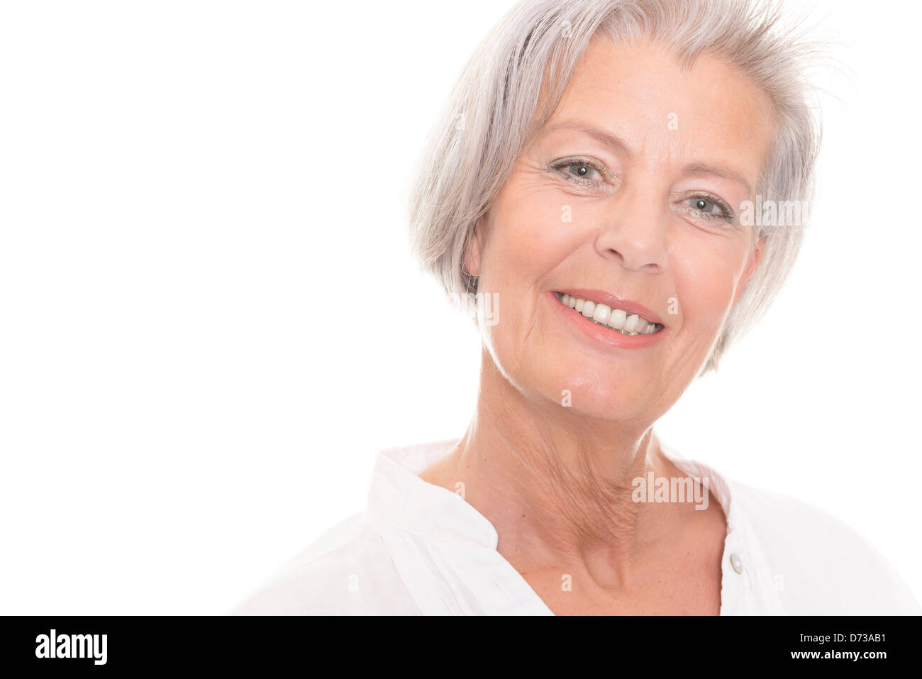 Smiling senior woman in front of white background Stock Photo - Alamy