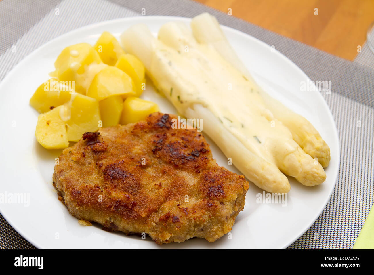 Escolope with white asparagus and potatoes Stock Photo
