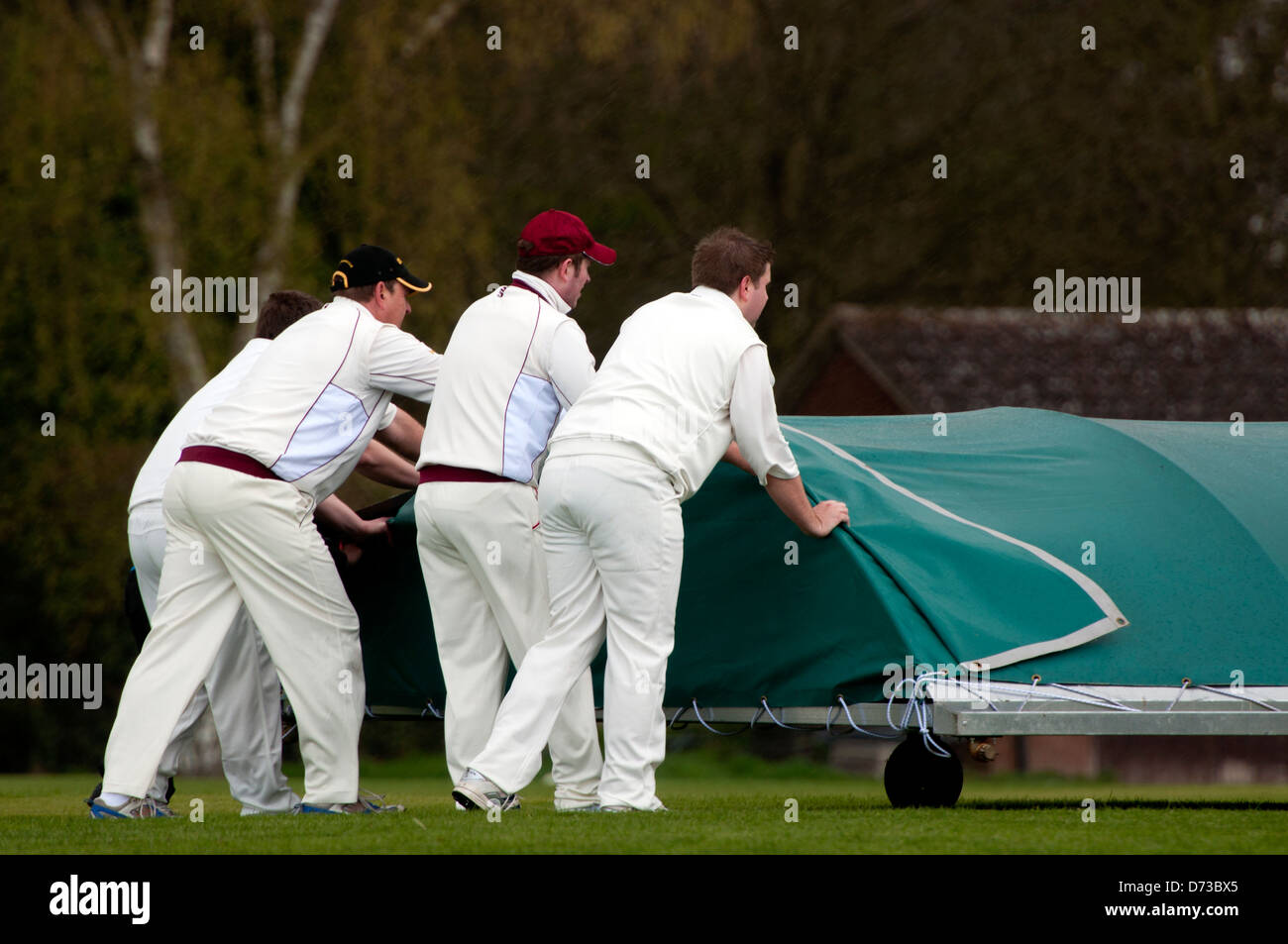 Village cricket at Leek Wootton, players moving the covers. Stock Photo