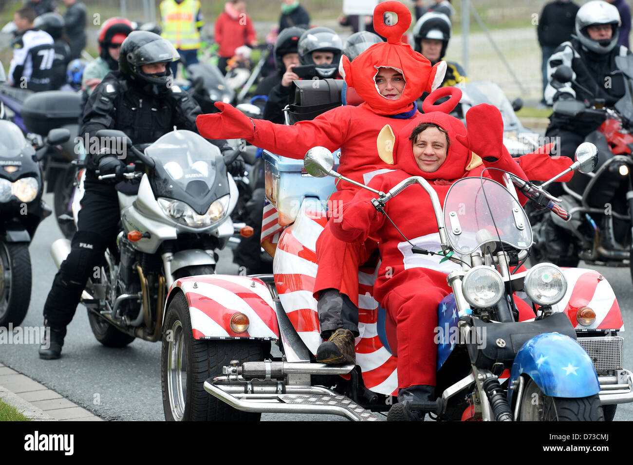 Participants of a motorcycle rally dressed as Teletubbies sit in a trike in Kulmbach, Germany, 28 April 2013. According to police, the motorcycle star ride in Kulmbach is the largest motorcycle rally in South Germany, which took place under the motto 'Arrive rather perish' for the 13th time. Photo: DAVID EBENER Stock Photo
