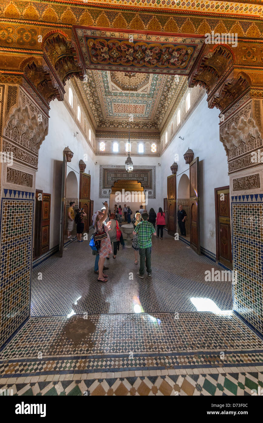 Marrakesh - the Bahia Palace. Visitors and interior with stained glass windows, Arabic design, tiling and plasterwork. Stock Photo