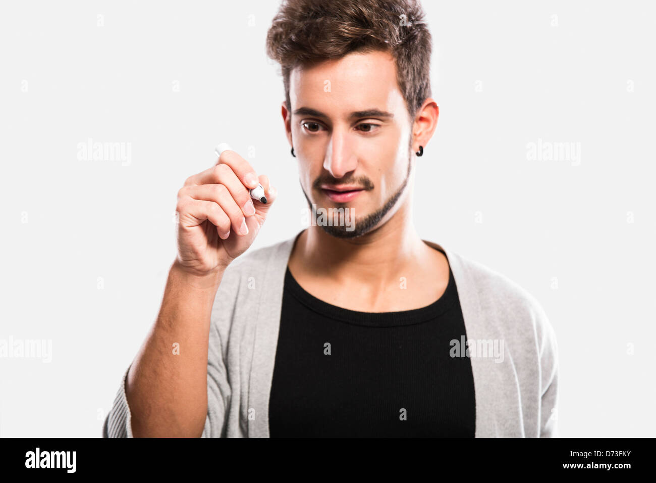 Portrait of a handsome young man writing something on a glass ...