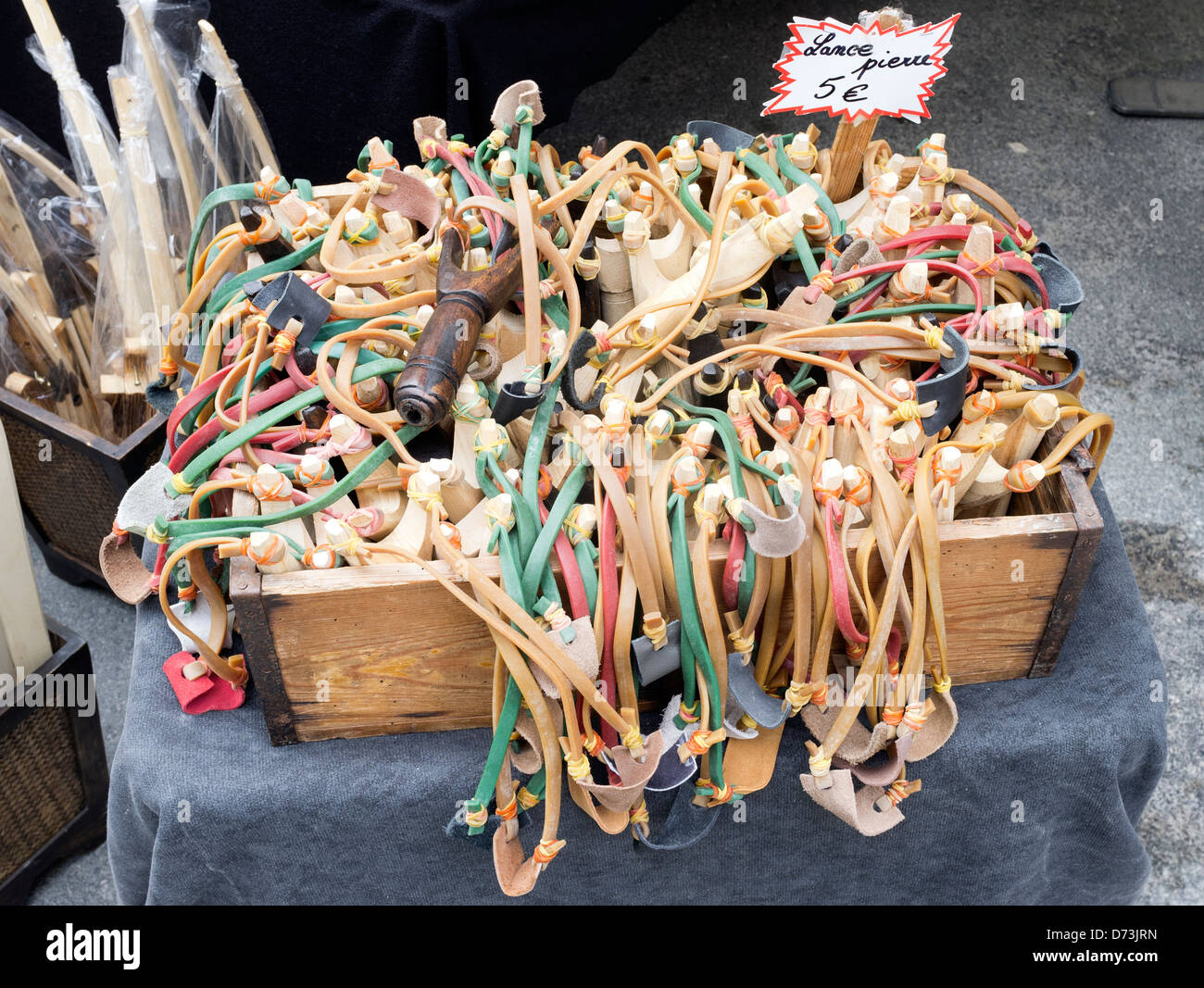 Wooden toy catapults for sale in Issigeac Sunday market a small French medieval village Dordogne Aquitaine South West France Stock Photo