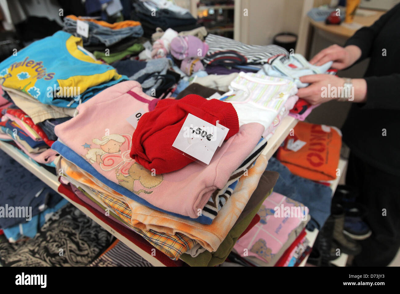 Flensburg, Germany, a woman is looking for children's clothing in the social department store of value Stock Photo