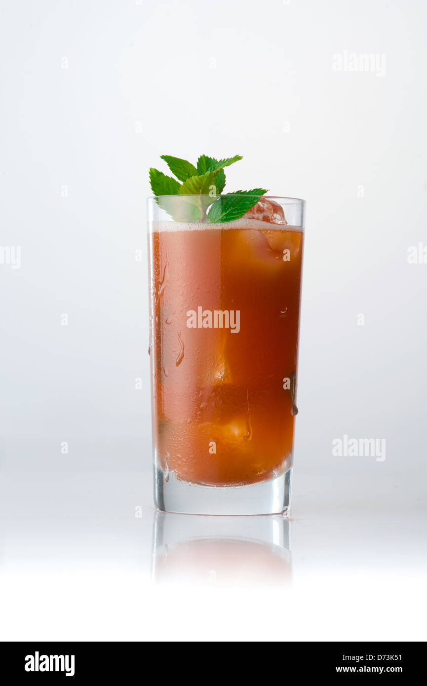 a glass of cold beverage with a leave of mint Stock Photo