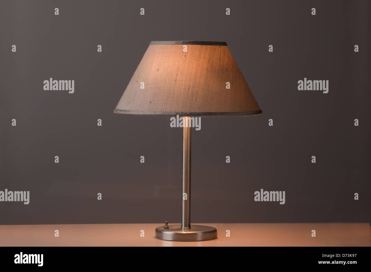 a lamp on a table with a yellow light Stock Photo