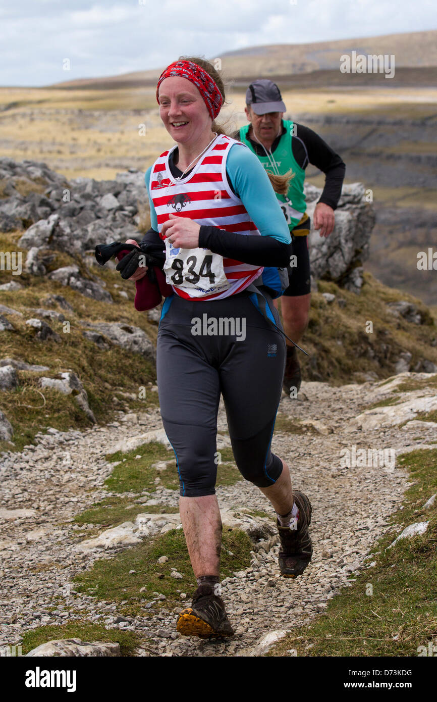 Yorkshire Three Peaks Challenge Saturday 27th April, 2013. Runner 834 Helen Buchan, 35 at the 59th Annual 3 Peaks Race with 1000 fell runners starting at the Playing Fields, Horton in Ribblesdale, Nr, Settle, UK.  Pen-y-Ghent is the first peak to be ascended then Whernside and finally the peak of Ingleborough. The race timed using the SPORTident Electronic Punching system Stock Photo