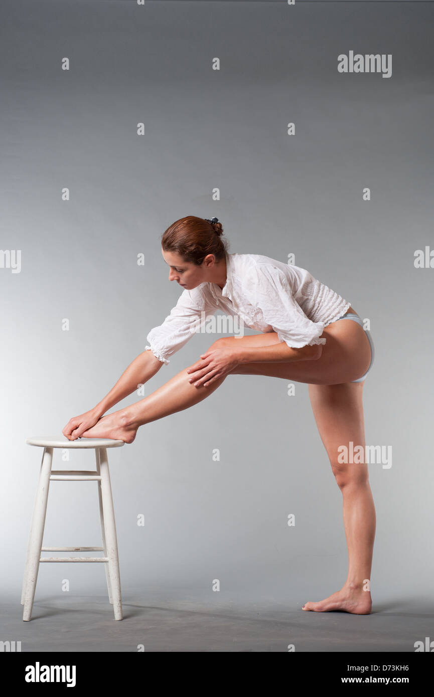 brunette girl in underwear touching her legs Stock Photo