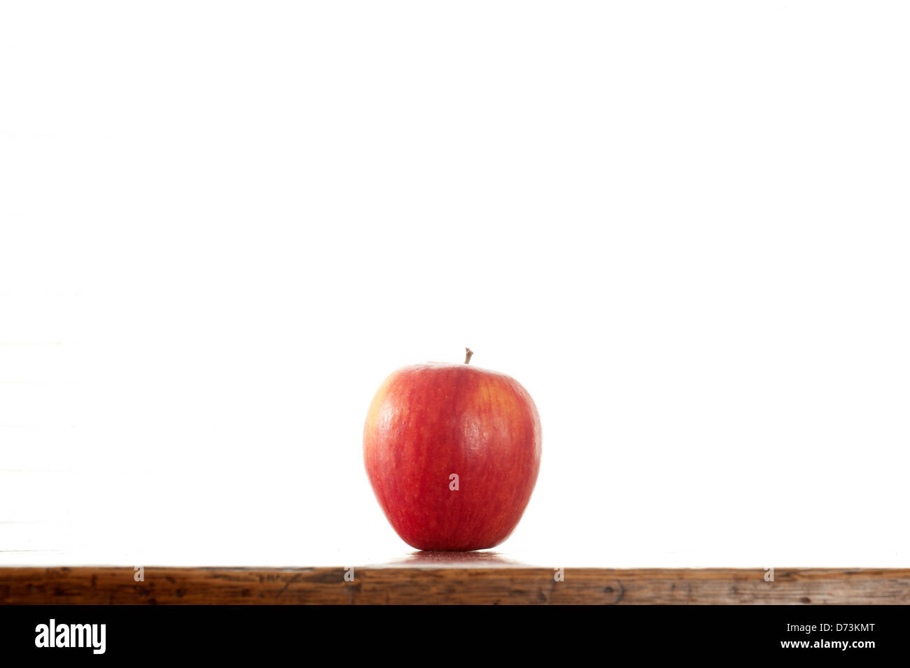 a red apple on a table Stock Photo