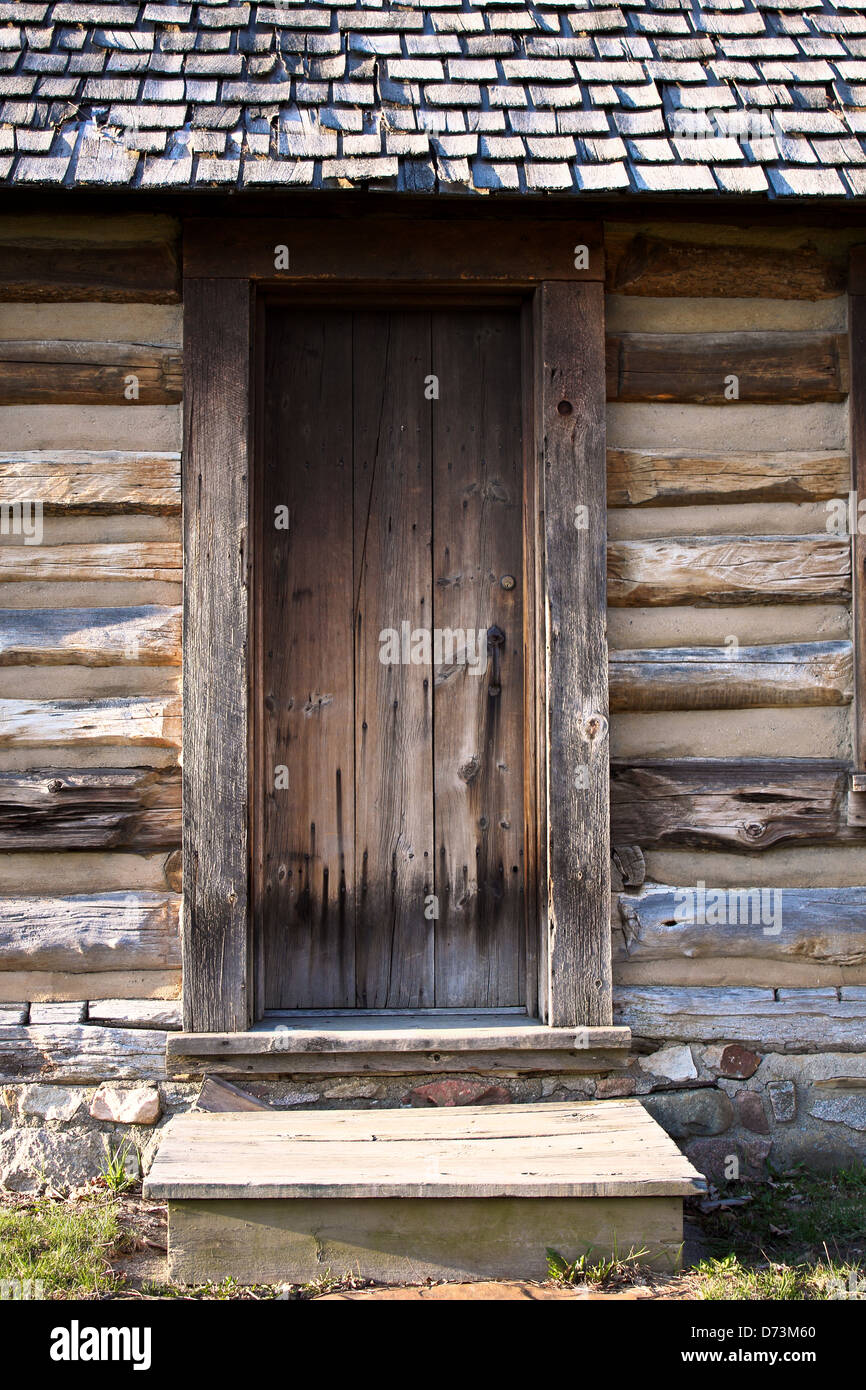 Restored pioneer log cabin door and step. Stock Photo