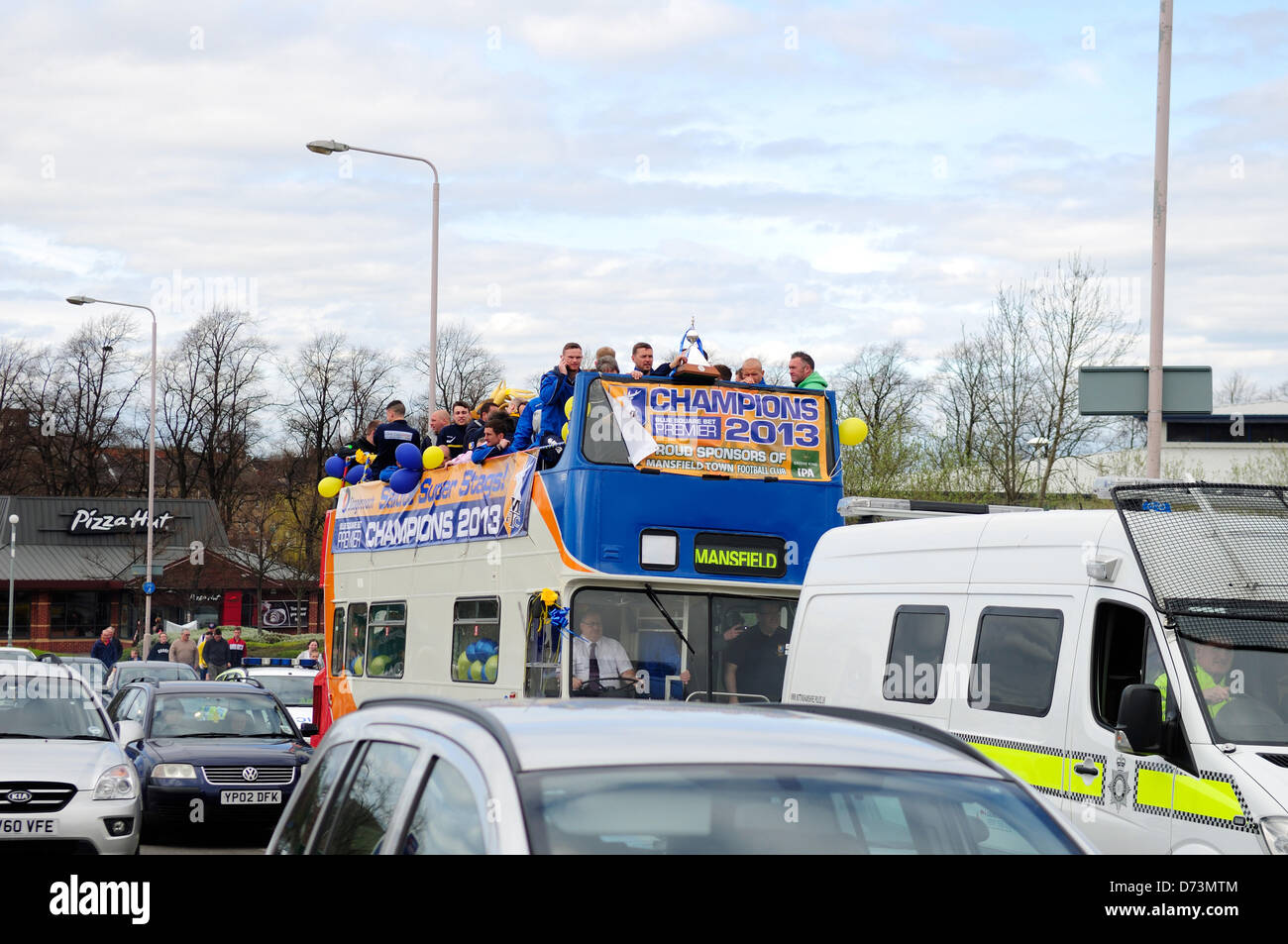 28th April 2013, Mansfield, Nottinghamshire, UK. Mansfield Town F.C. celebrate promotion back to league football next season (2013-2014)with an open top bus tour of the town.Fans turned out along the route singing and chanting as the team bus past by. Alamy Live News. Stock Photo