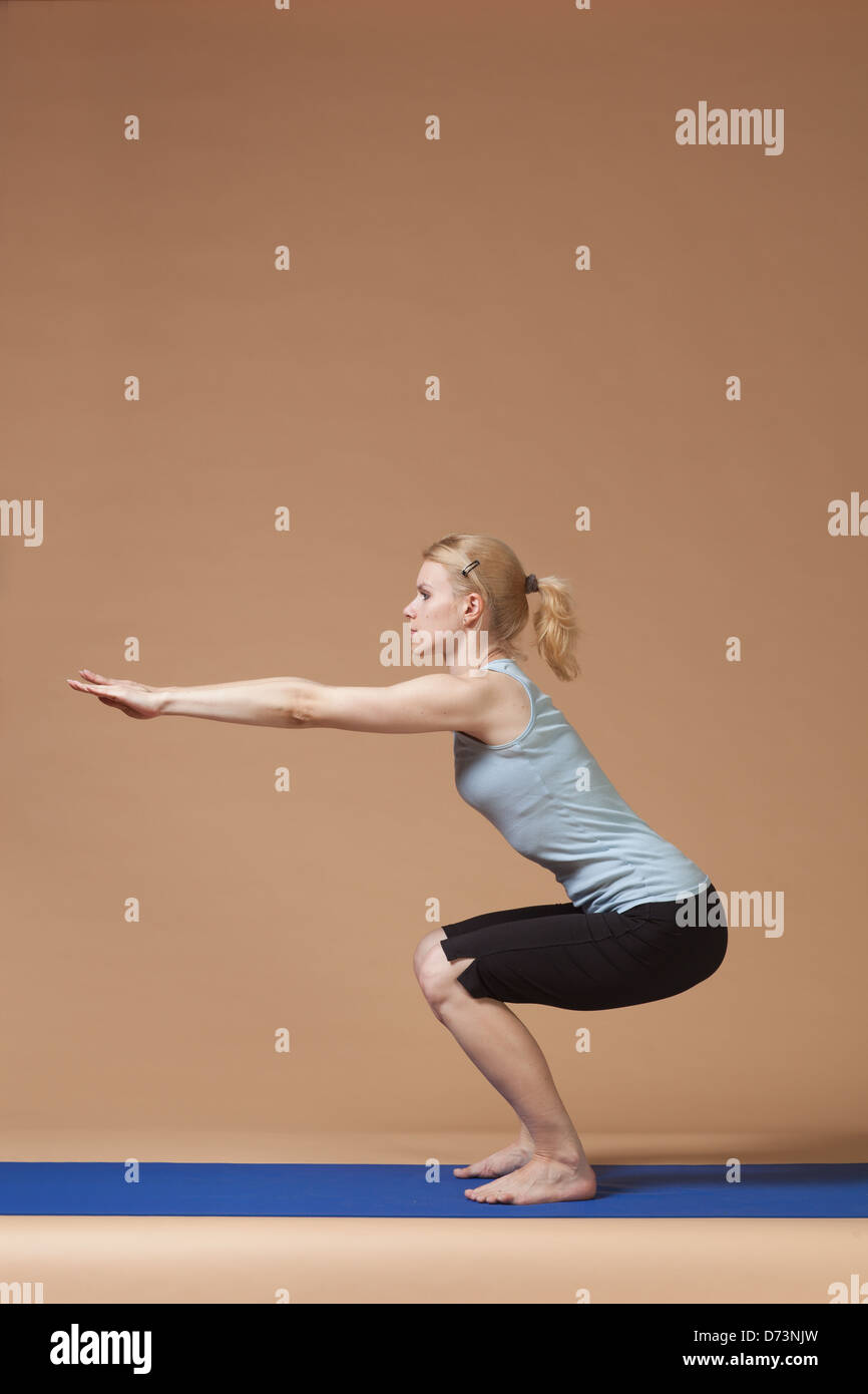 blonde girl doing yoga Stock Photo