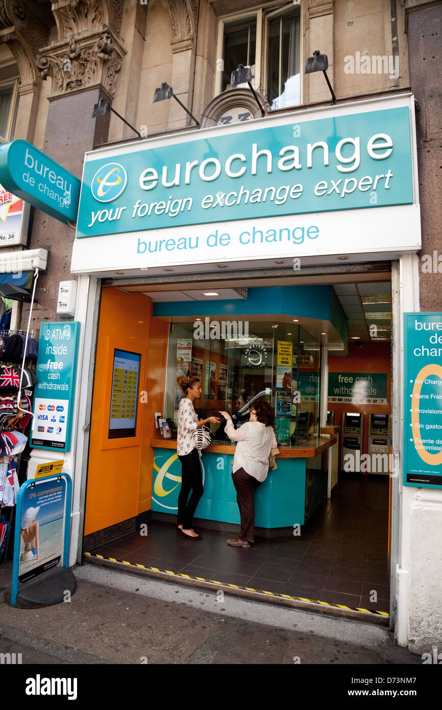 People in a Eurochange bureau de change travel money cash shop, Piccadilly Circus, central London UK Stock Photo