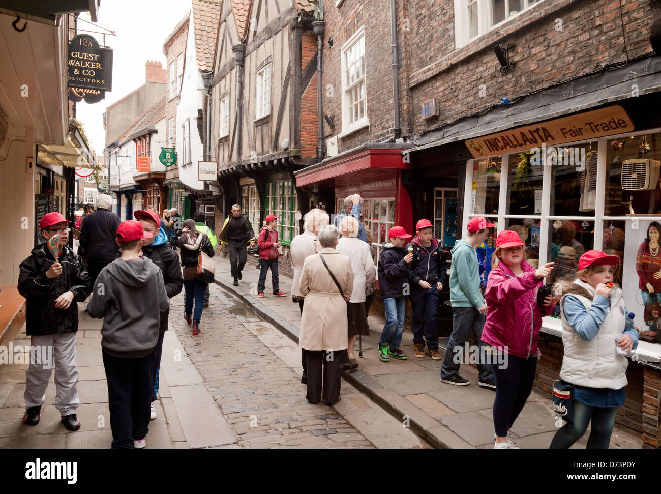 Schoolchildren and other people in a street scene, the Shambles, York old city, Yorkshire England UK Stock Photo