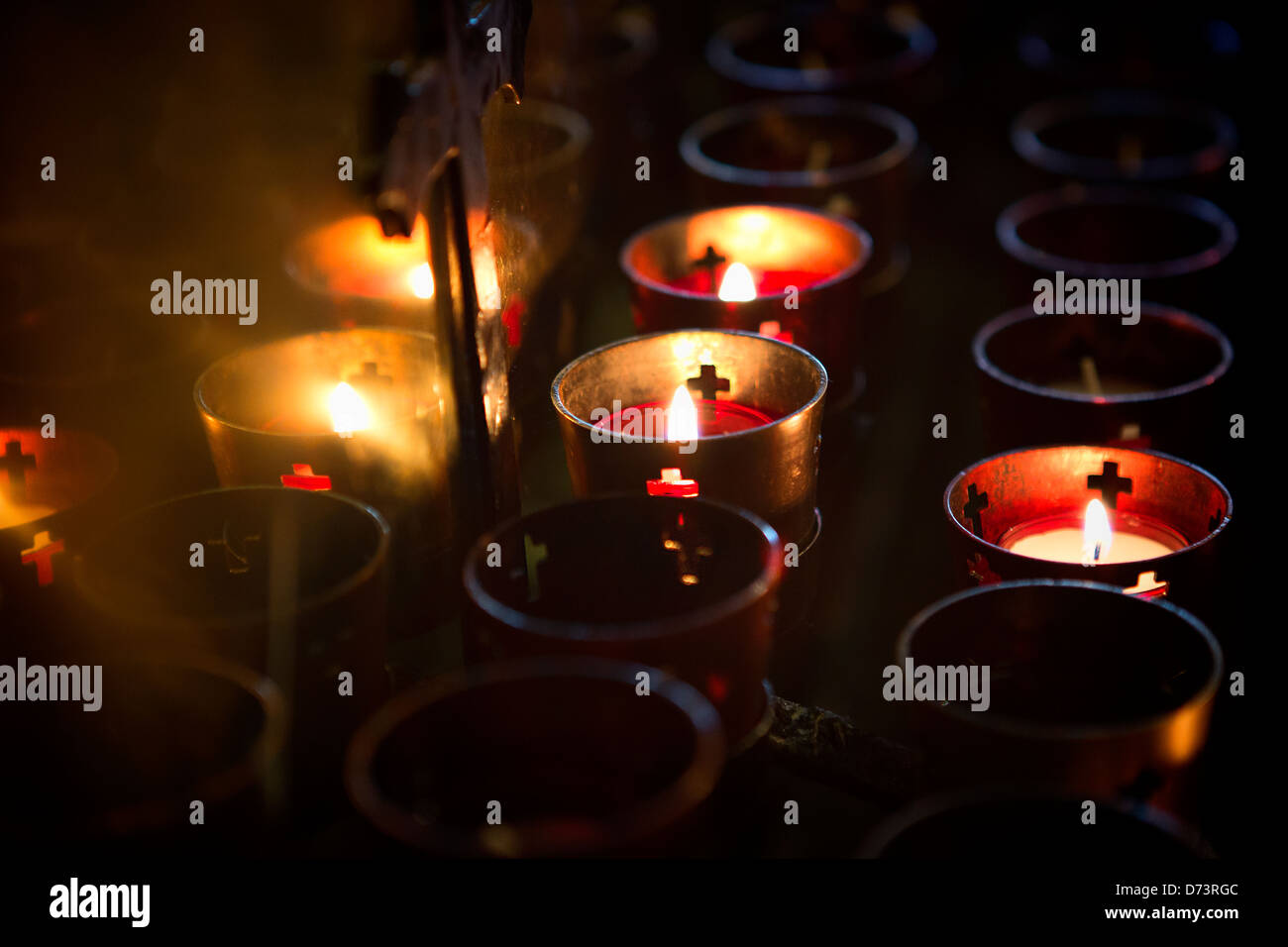 Devotional candles lighting a darkened Roman Catholic Basilica of the