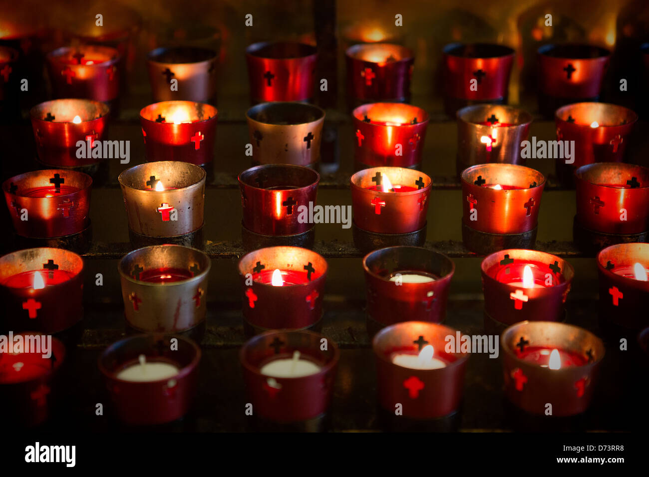 Devotional candles lighting a darkened Basilica of the National Shrine