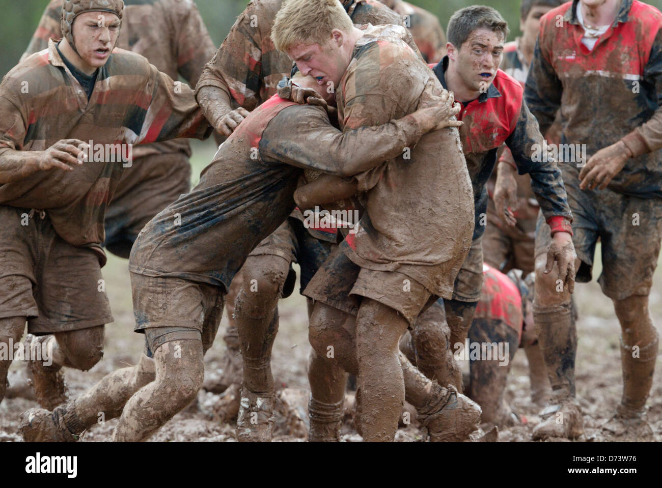 Teams battle in the mud during a game at the annual Cherry Blossom Rugby Tournament. Stock Photo