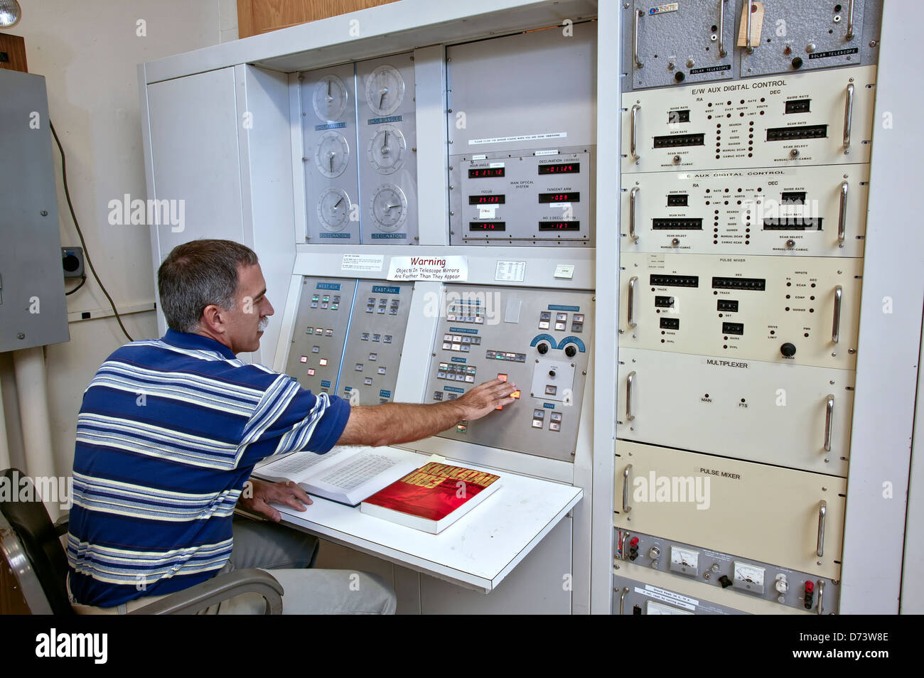 Astronomer observing data, control panel for the telescope system Stock