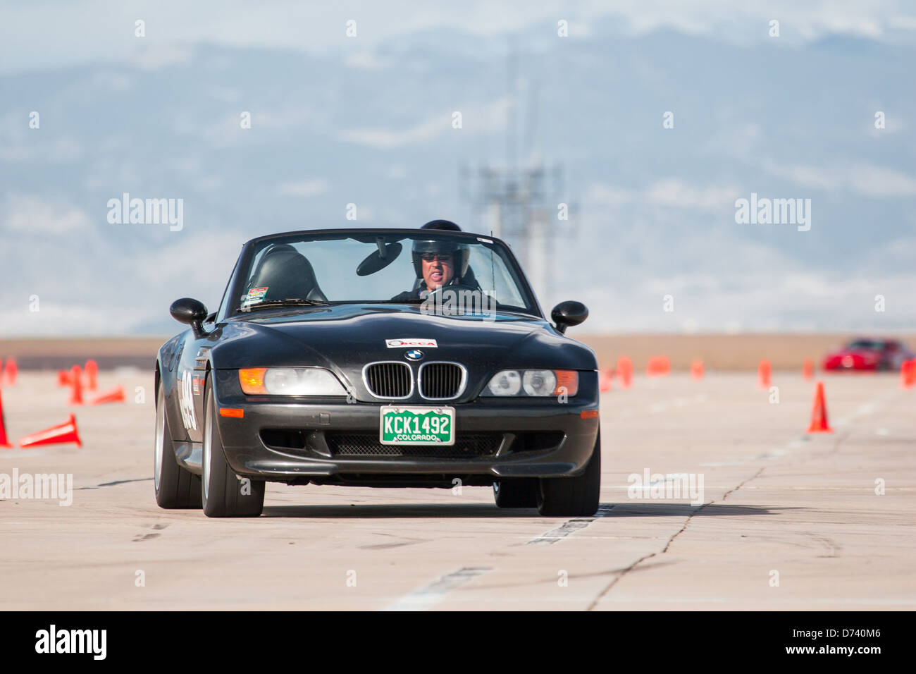 A 1998 Black BMW M Roadster Convertible in an autocross race at a ...