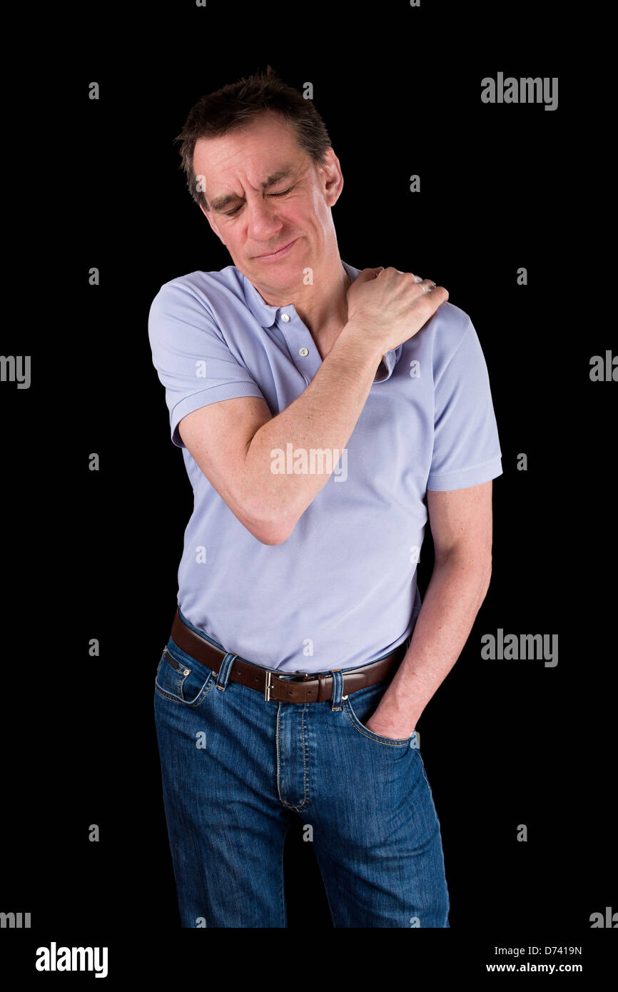 Middle Age Man Holding Shoulder in Pain Black Background Stock Photo
