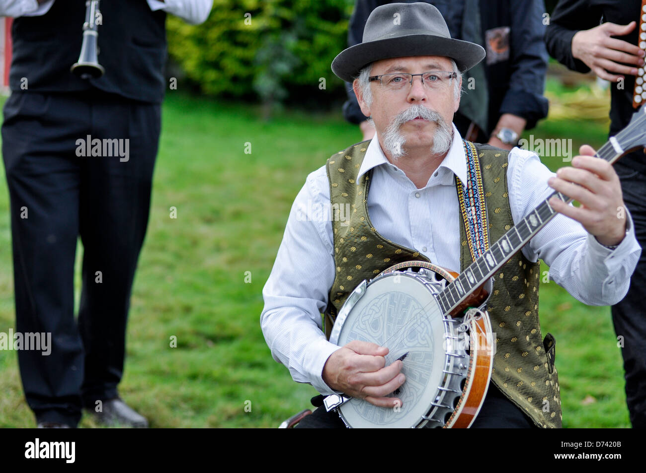 Old musician  with hat playing the banjo Stock Photo