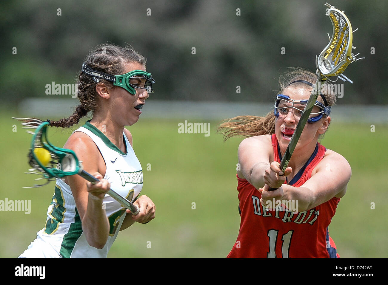 April 28, 2013: Detroit Titans defender Britany Busch (11) attempts to defend a goal shot by Jacksonville attack Brittney Orashen (29) during NCAA Women's Lacrosse ASUN Championship game action between the Detroit Mercy Titans and the Jacksonville Dolphins. Jacksonville defeated Detroit Mercy 22-8 at Southern Oaks Stadium in Jacksonville, FL Stock Photo