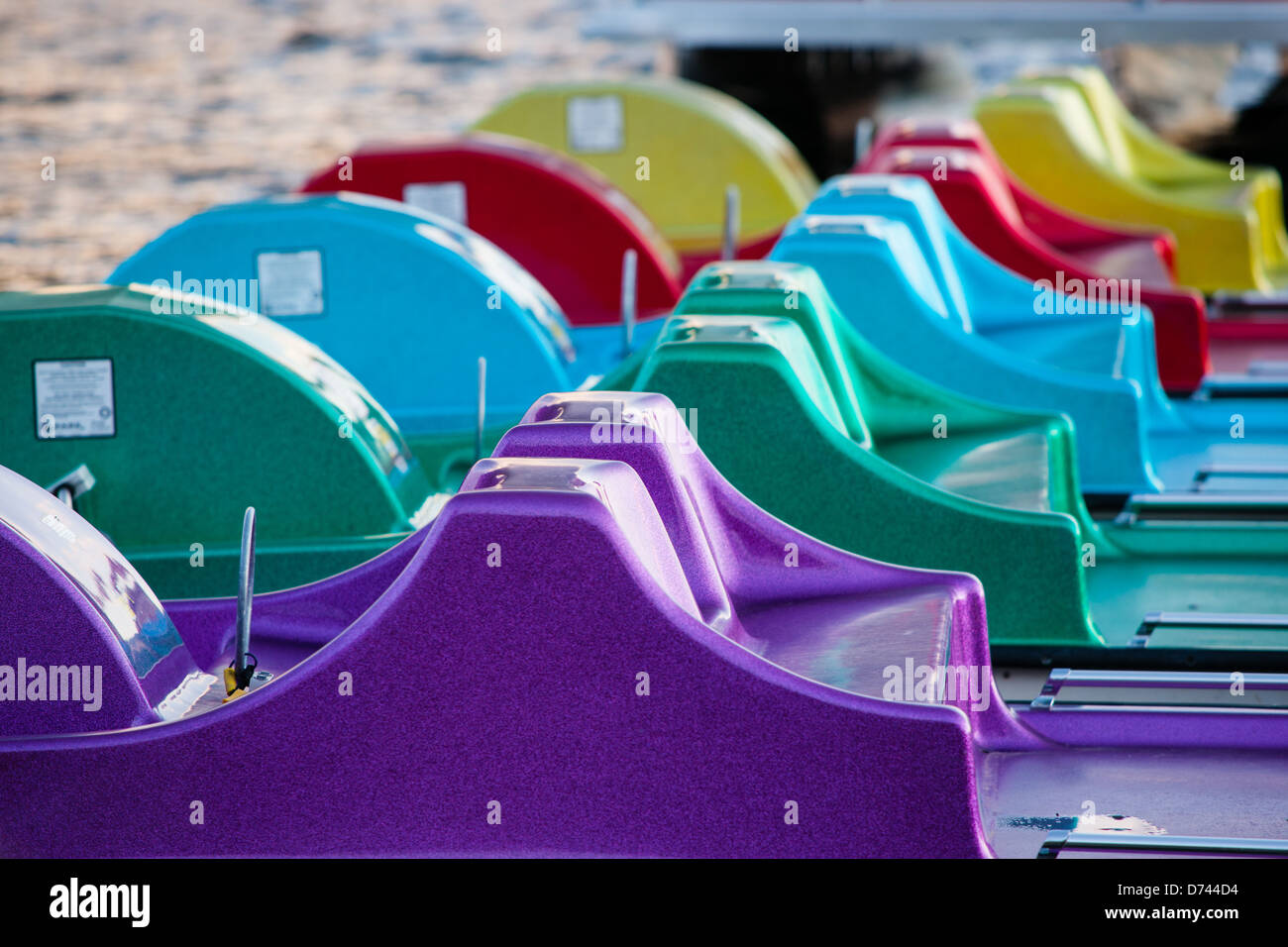 Five pedalo (paddle boats) painted in the colors of the rainbow