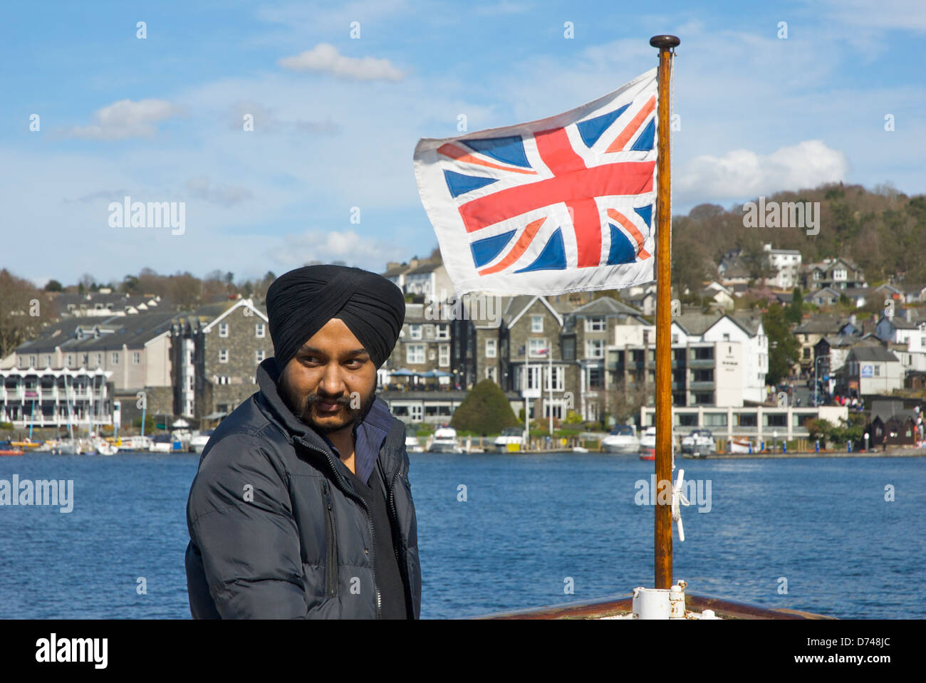 Asian man on passenger steamer, Lake Windermere at Bowness Bay, Lake District National Park, Cumbria, England UK Stock Photo