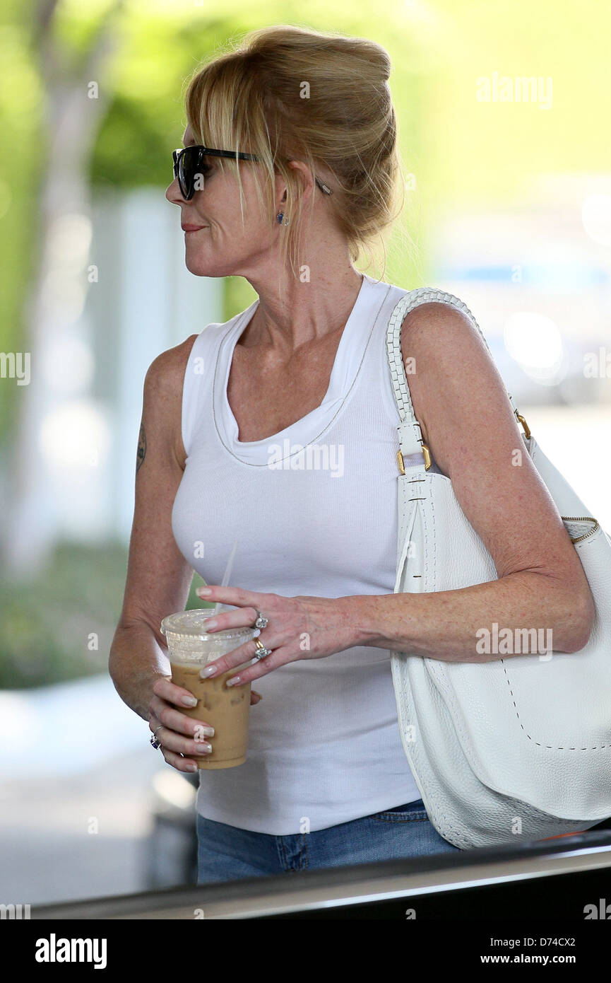 Melanie Griffith drinking iced coffee as she leaves Saks Fifth Avenue Beverly Hills Los Angeles, California - 02.08.11 Stock Photo