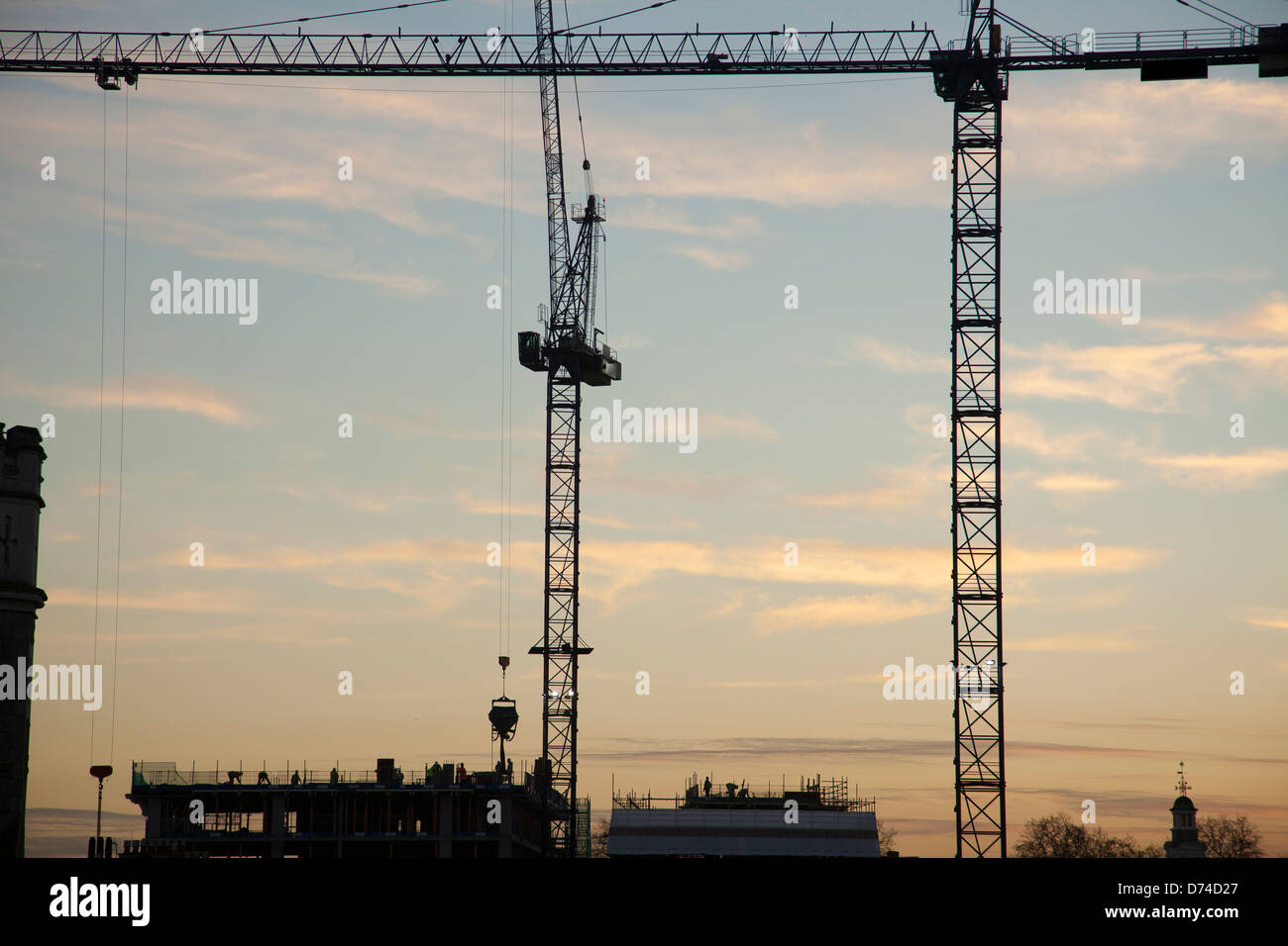 Construction, Cranes silhouetted against sunset, London, UK Stock Photo