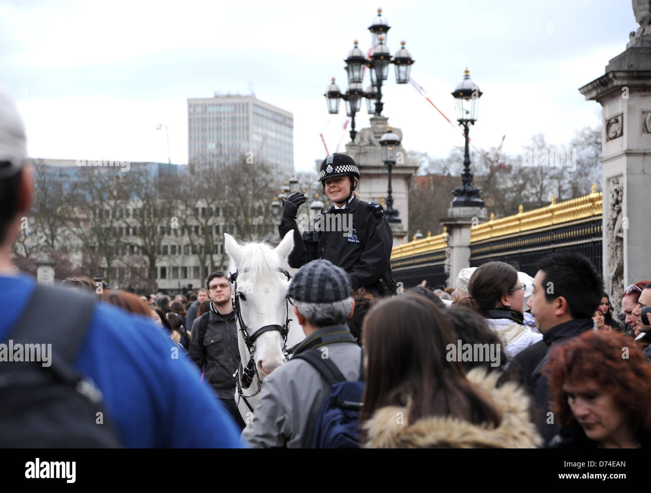 Female police officer on horseback helps with crowd control at the Changing of the Guard at Buckingham Palace in London UK Stock Photo