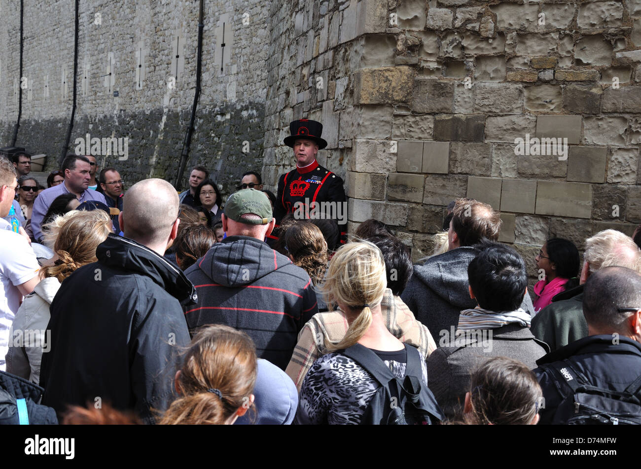 Tourists listening to Beefeaters at the Tower of London Stock Photo