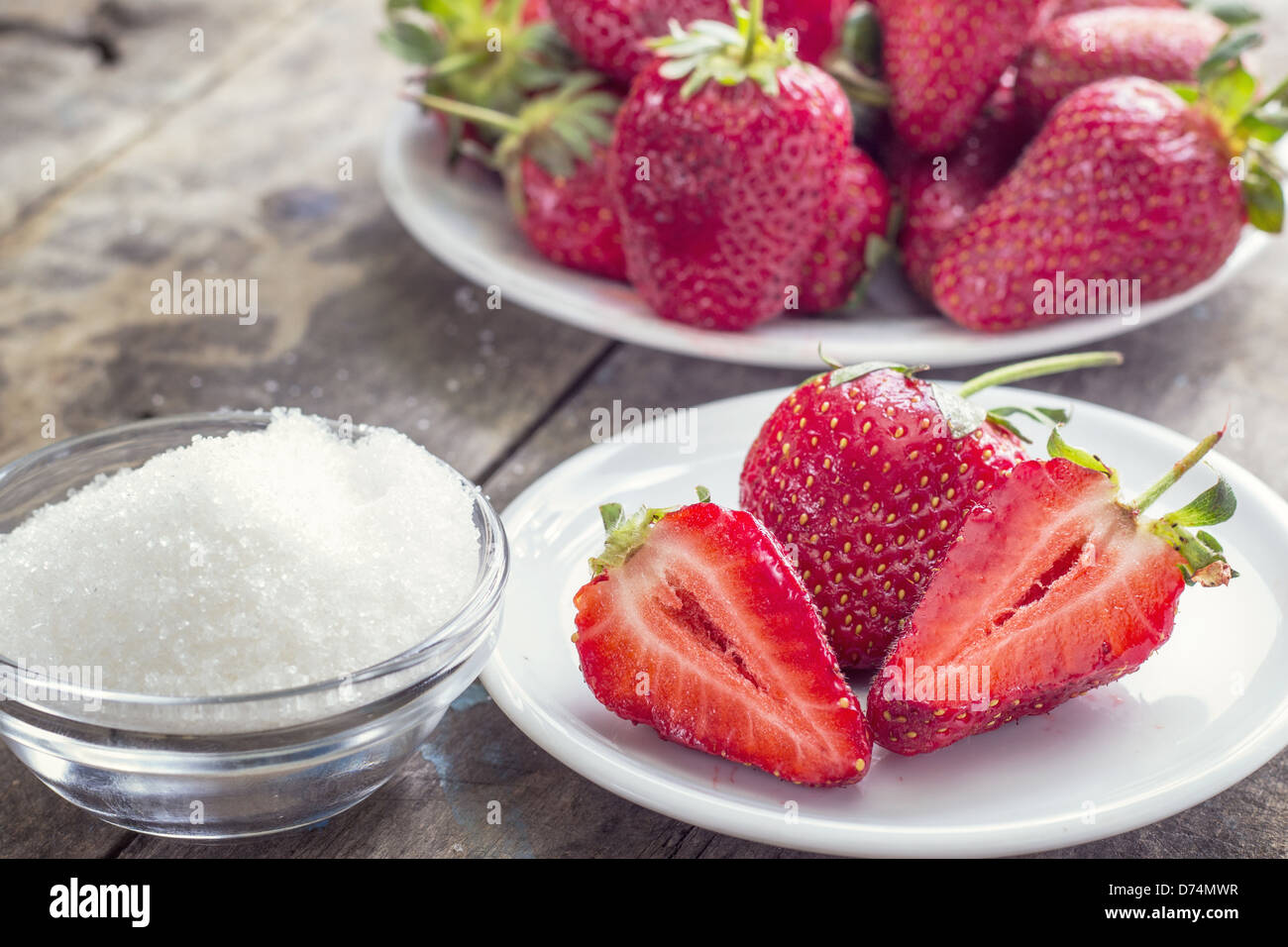 strawberries and sugar on the wooden table Stock Photo - Alamy