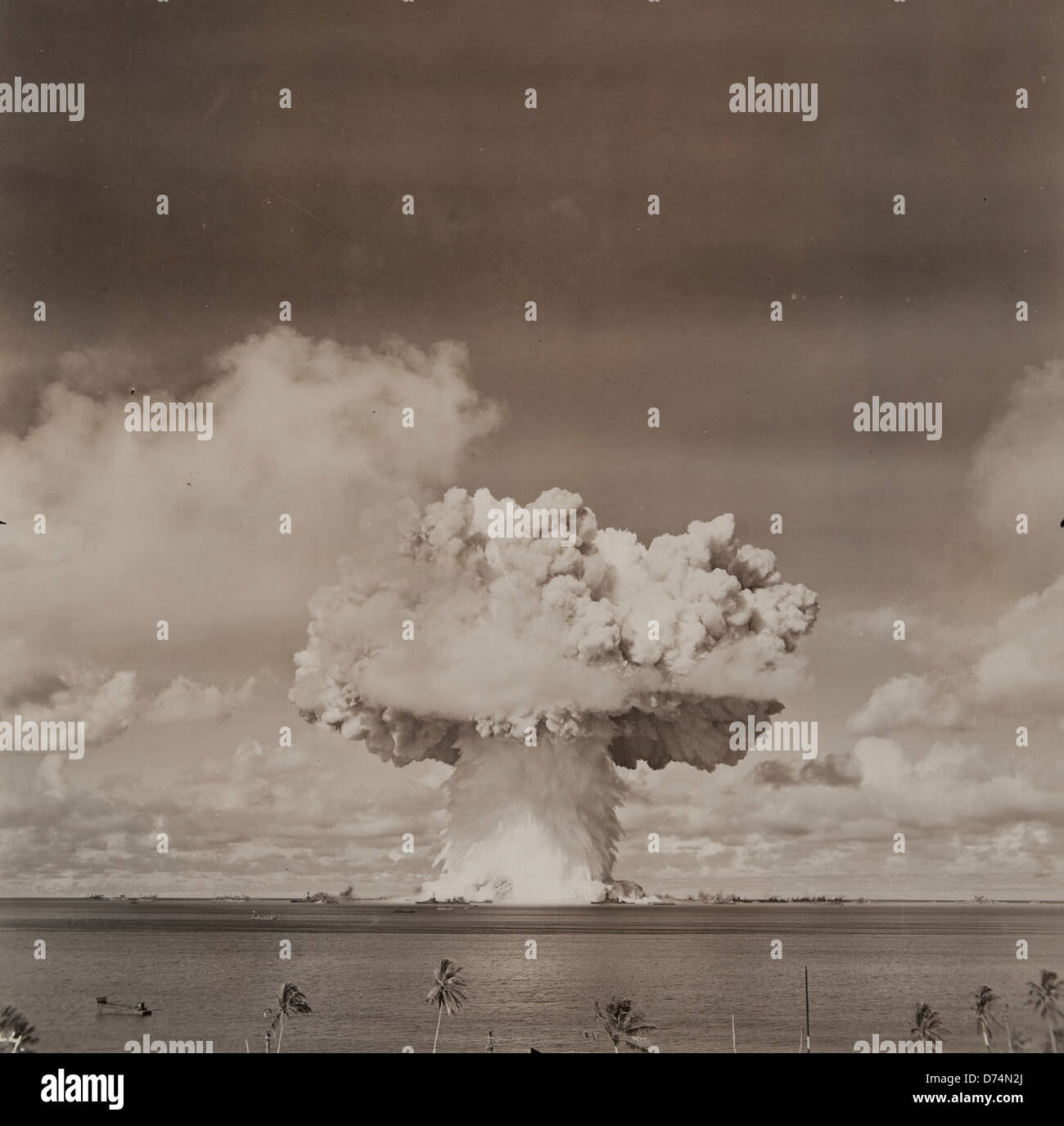 A historic photograph of the atomic bomb blast at Bikini Atoll, showcasing one of the major nuclear tests conducted by the U.S. The image is part of the Museum of Photographic Arts collection, documenting nuclear history. Stock Photo