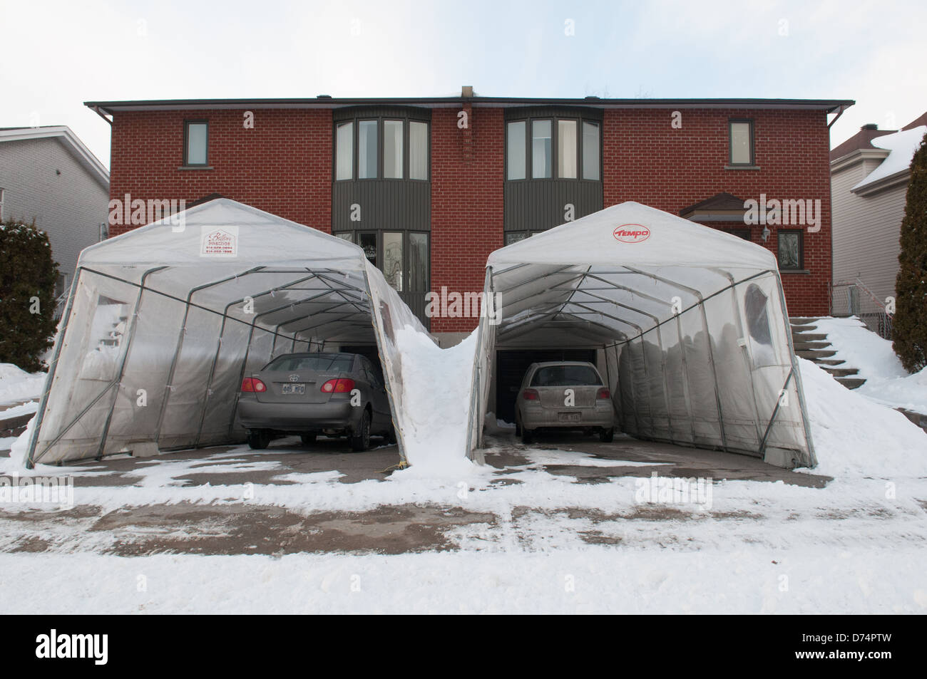 Temporary Tempo car shelters in a suburb of Montreal Canada - These are very popular bcse of harsh winter Stock Photo