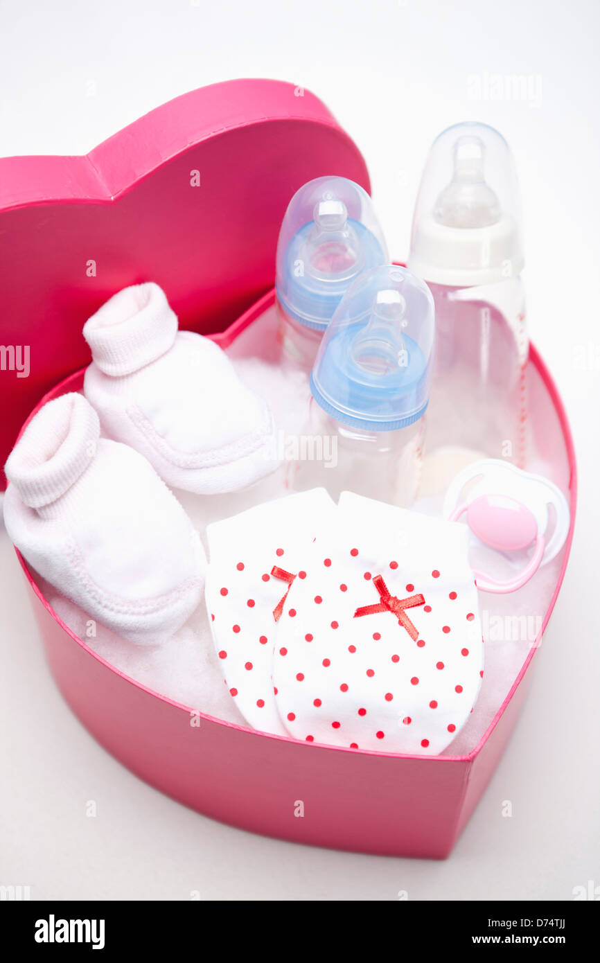 https://c8.alamy.com/comp/D74TJJ/a-pink-heart-box-filled-with-baby-items-D74TJJ.jpg
