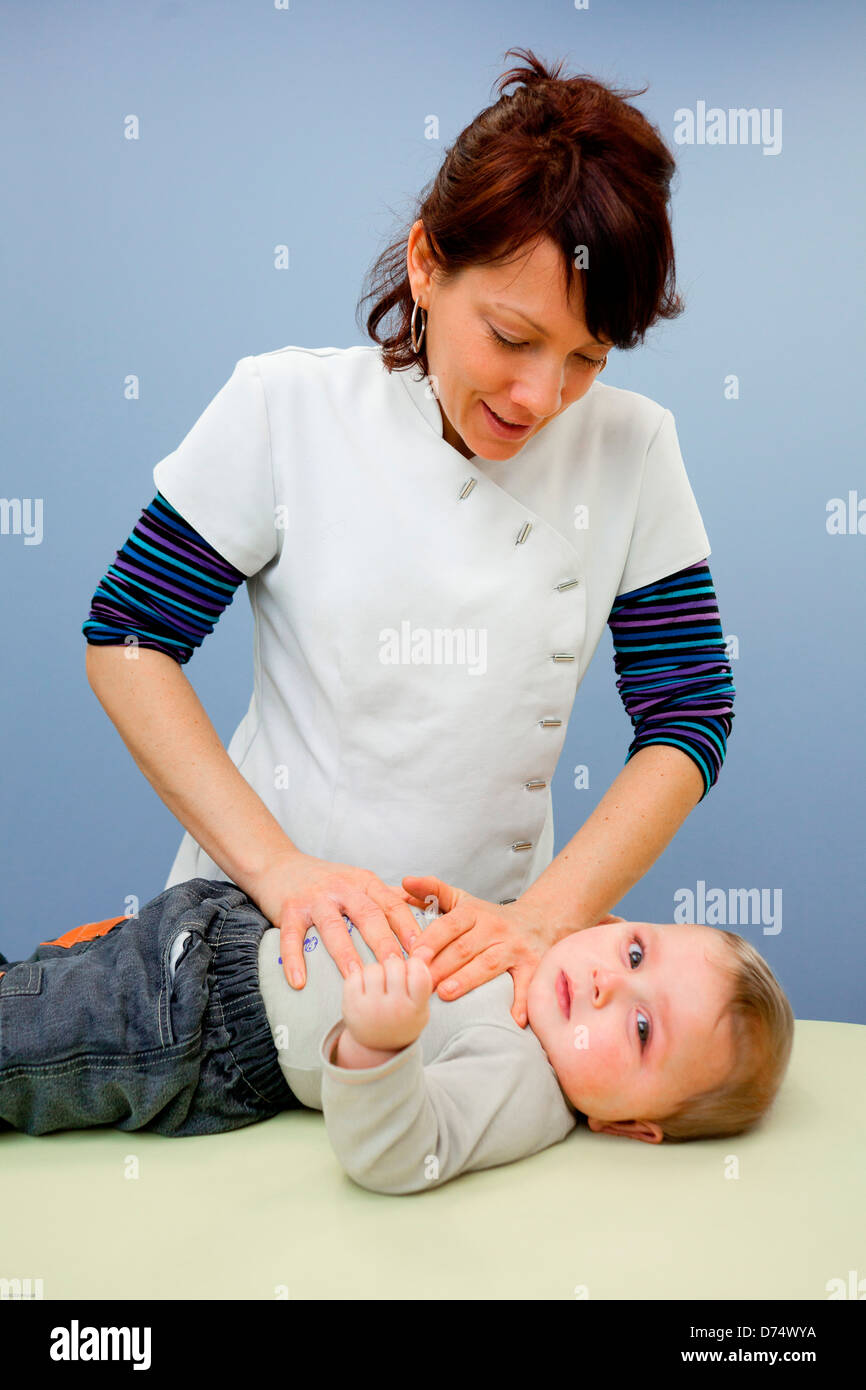 Physical Therapist performing respiratory physiotherapy on baby Stock