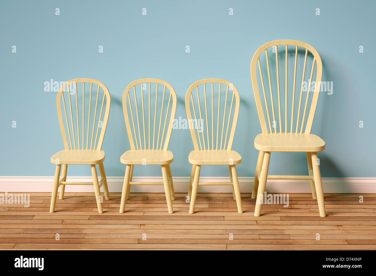 Row of empty chairs - three small, one large Stock Photo