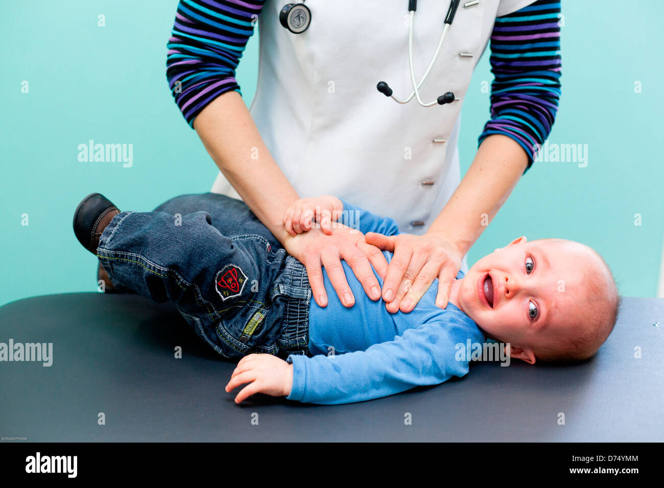 Physical Therapist performing respiratory physiotherapy on baby Stock
