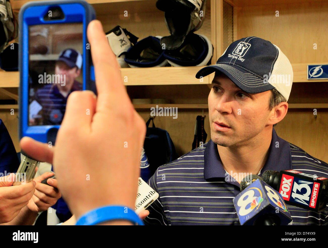 Tampa, Florida, USA. 29th April, 2013. Tampa Bay Lightning Marty St. Louis talks with the media in the locker room as the Lightning's season comes to a close with another season of not making the playoffs at the Tampa Bay Times Forum in Tampa monday morning 04/29/13. St. Louis and Steven Stamkos were the NHL's top two point producers and yet finished out of the playoffs for the fifth time in six years. St. Louis, the 37-year-old right wing became the oldest player to win an NHL points title with 60 on 17 goals and a league-best 43 assists. Extrapolated over a normal 8 Stock Photo