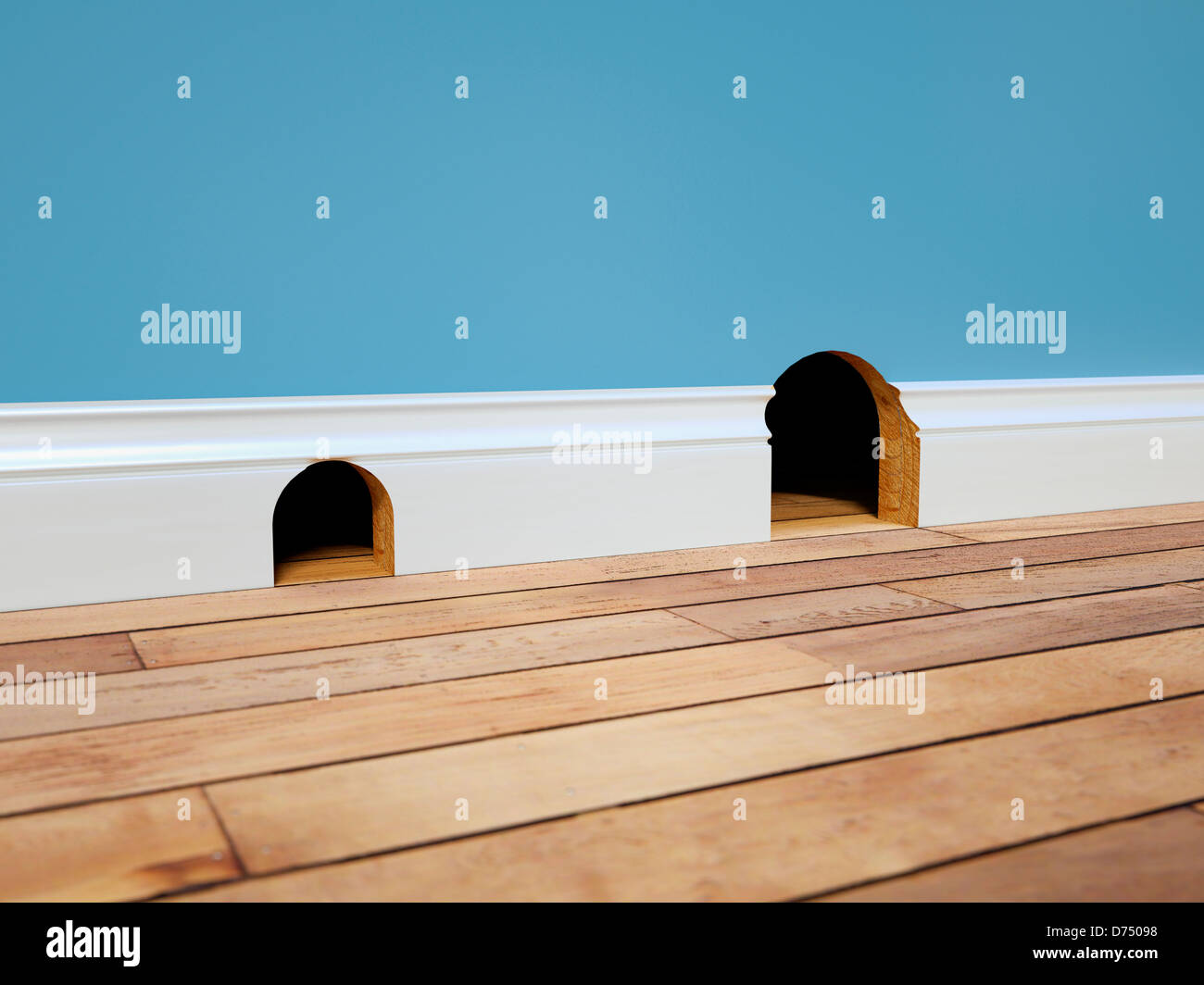 Two mouse holes - housing, real estate concept / trading up / up sizing / down sizing Stock Photo