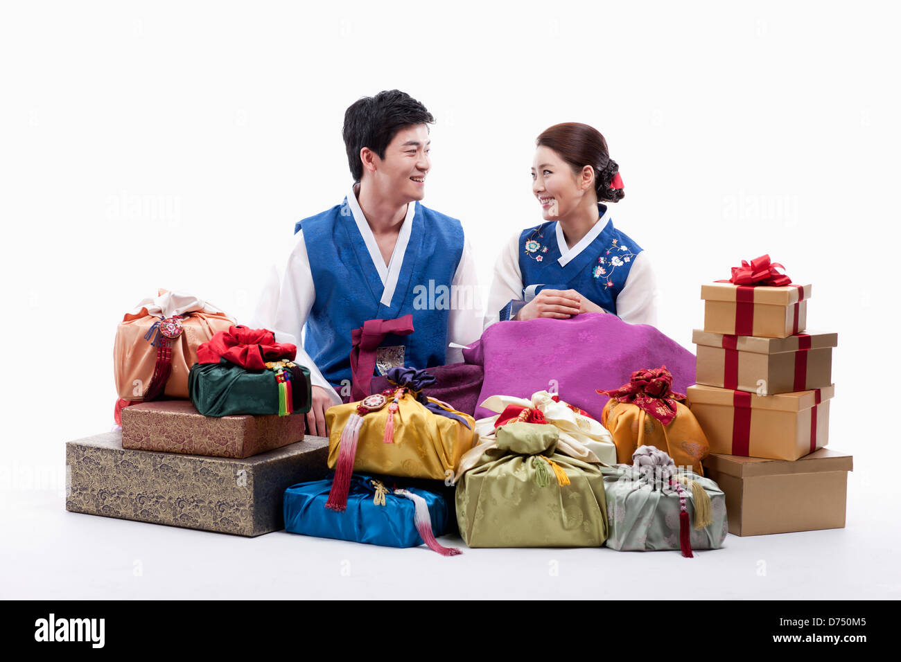 a man and a woman in Korean tradition costume behind gifts Stock Photo