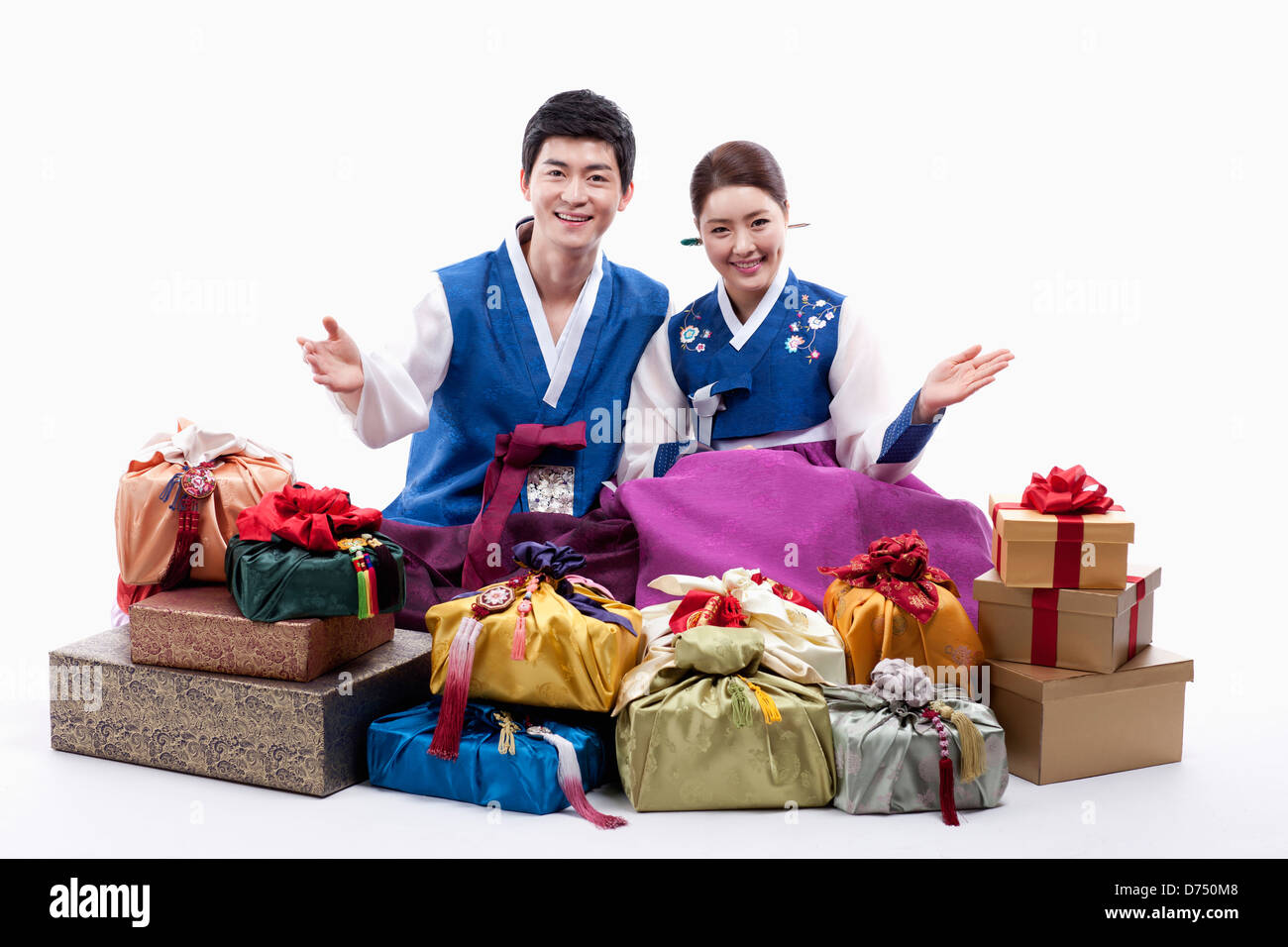 a man and a woman in Korean tradition costume behind gifts Stock Photo