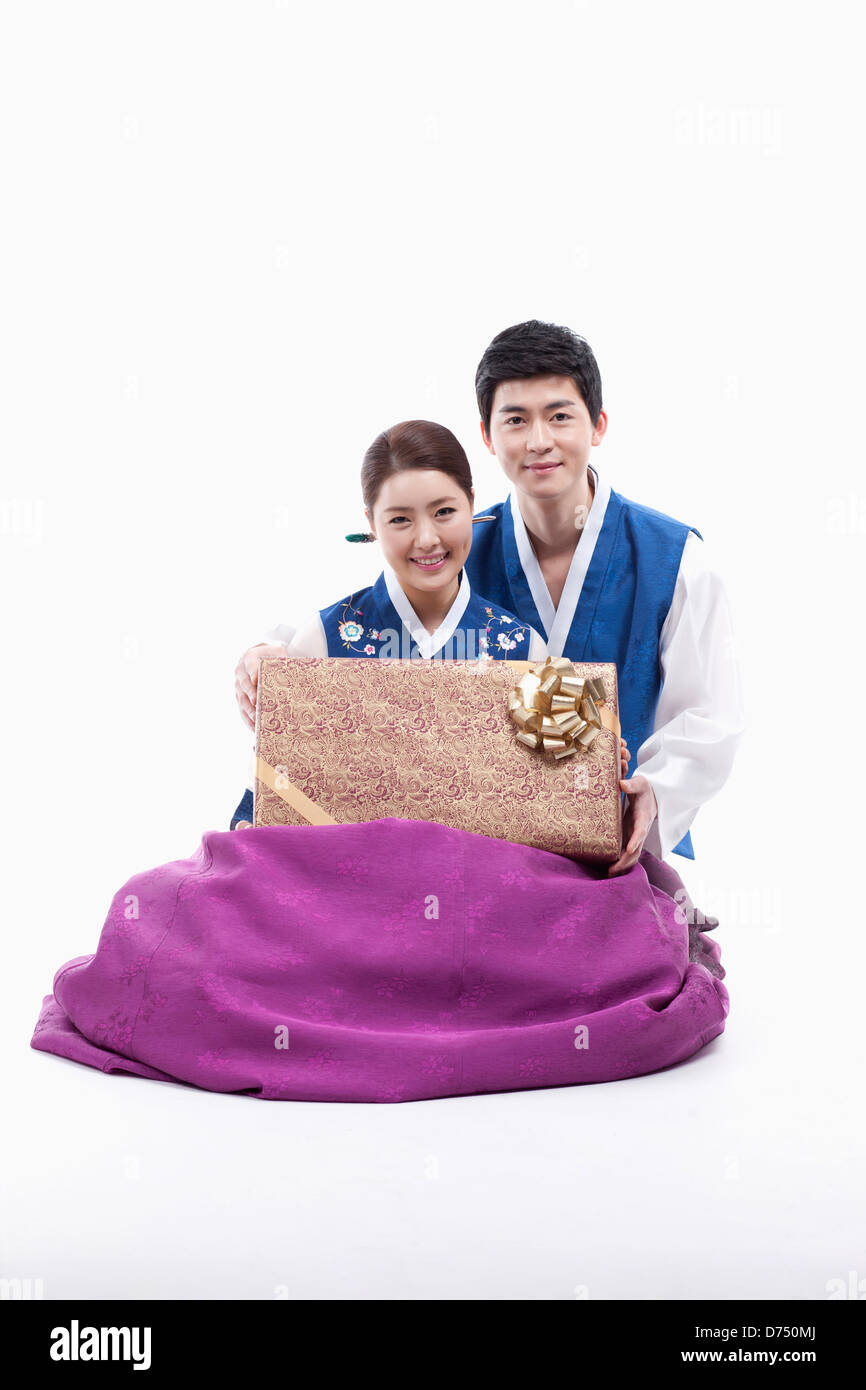 a couple in Korean tradition costume holding a gift Stock Photo