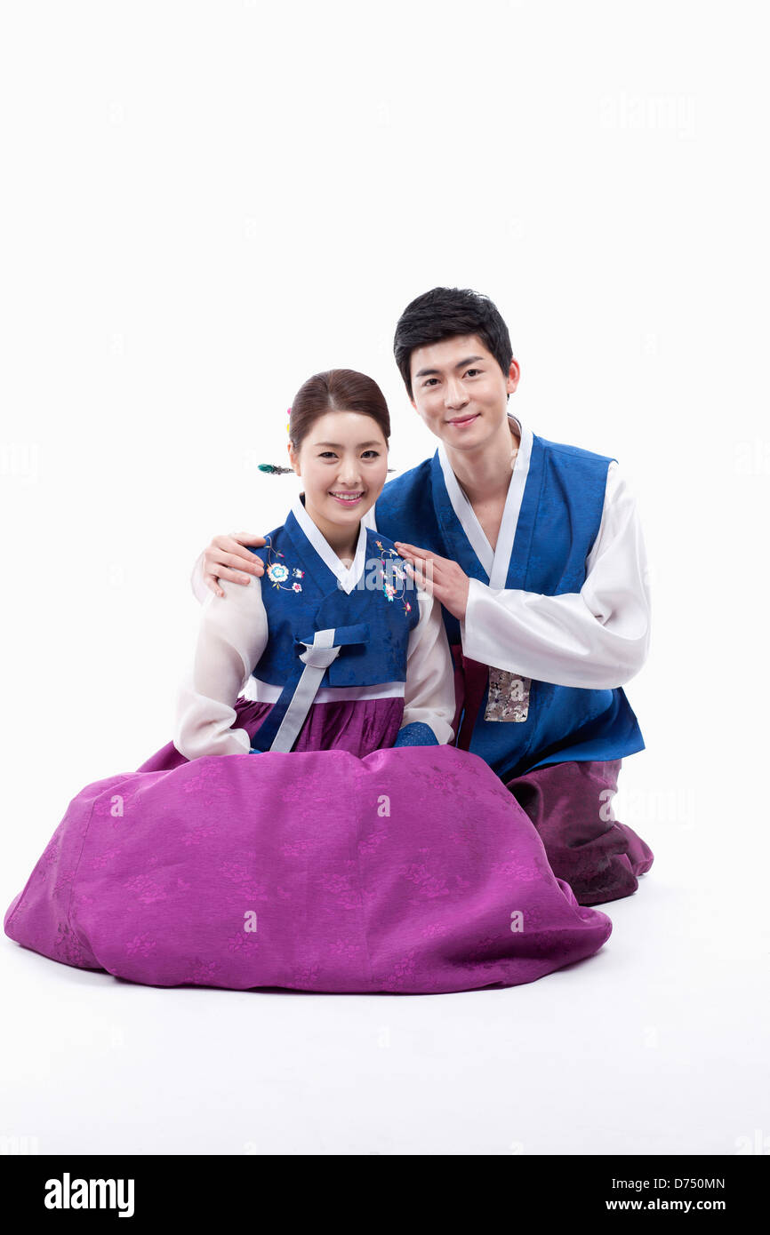 a couple in Korean tradition costume sitting on the floor Stock Photo