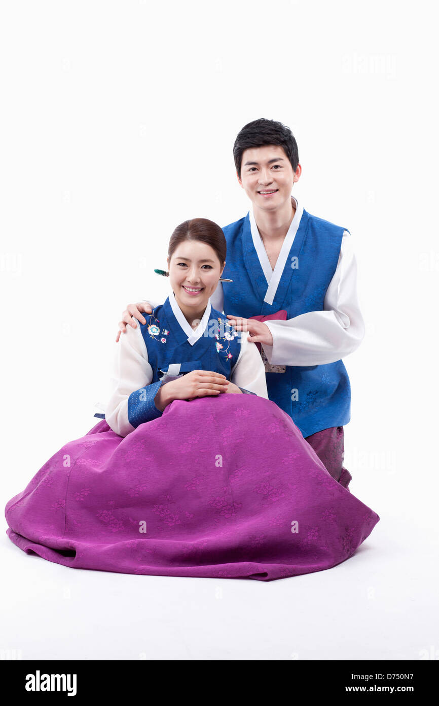 a couple in Korean tradition costume sitting on the floor Stock Photo