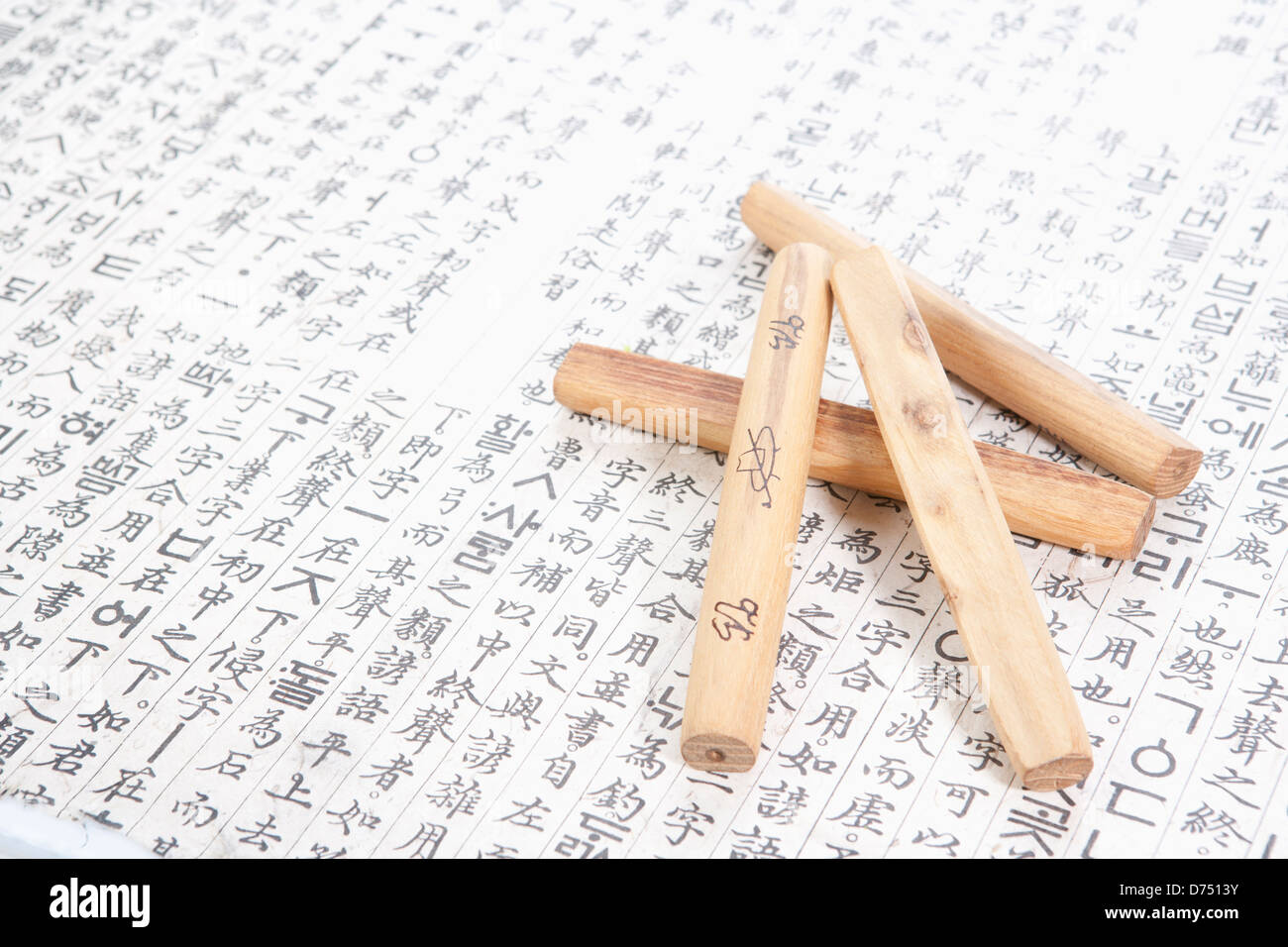 Yut sticks on a paper with traditional Korean words Stock Photo